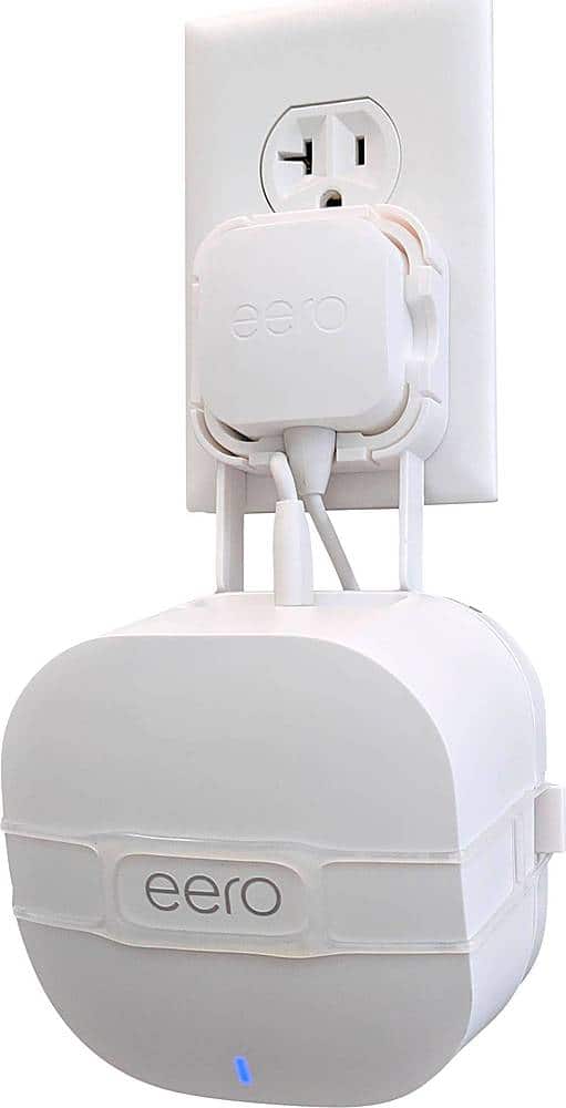 Installing Mount Genie Easy Outlet Mount for eero 6 Wi‑Fi on a wooden desk